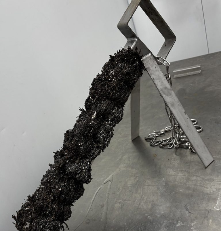Open-body Innovar Ditch Magnet loaded with ferrous debris along the full length